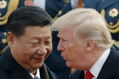 Presidentes de Estados Unidos y China estrechando manos tras firma de acuerdo comercial