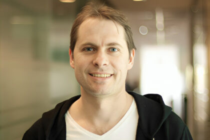 Piloto de Fórmula 1 usando inteligencia artificial en simulador de racing con pantallas de datos en tiempo real