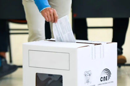 Urnas electorales con votantes ecuatorianos durante consulta popular en Ecuador 2025 en centro de votación nacional