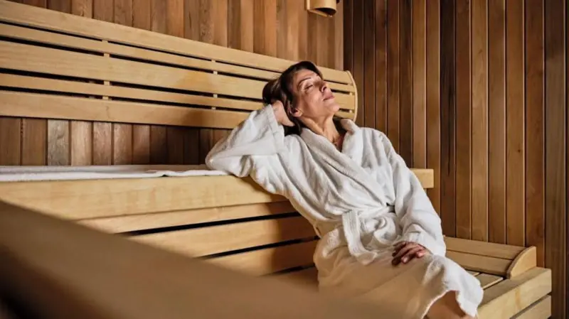 Personas disfrutando de un sauna y un baño en agua fría como parte de un ritual de bienestar
