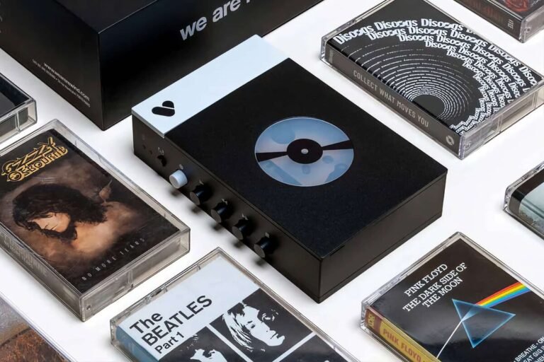 Un reproductor de cassette de aluminio moderno con conectividad Bluetooth junto a varias cintas magnéticas sobre una mesa, representando la tendencia del hardware retro.