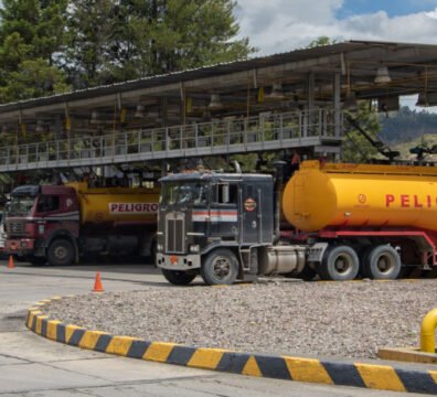 Importaciones de Ecuador desembarcando contenedores de mercancías y combustibles en el puerto comercial.