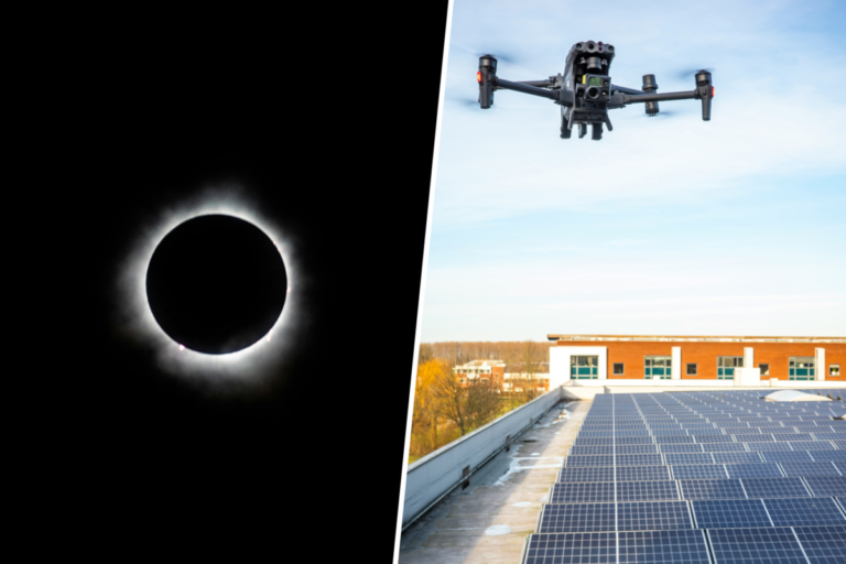 Vista aérea de un parque de paneles solares bajo un cielo oscurecido que ilustra el impacto de los eclipses en la red eléctrica.