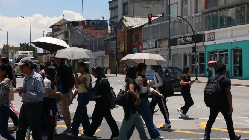 Habitantes se protegen del sol durante un período de altas temperaturas asociado al Fenómeno de El Niño en Quito.