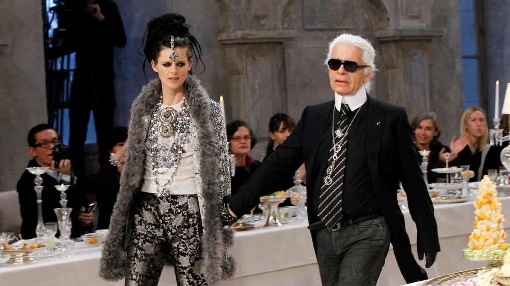 Karl Lagerfeld diseñador de moda con traje negro y gafas oscuras