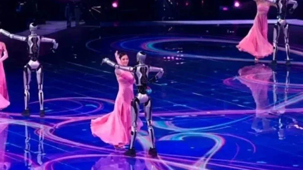 Robots humanoides bailando con bailarines profesionales en escenario