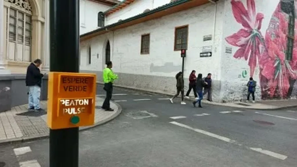 Agentes de tránsito de la UCOT explican a la ciudadanía el nuevo botón peatonal para semáforos en el centro de Loja