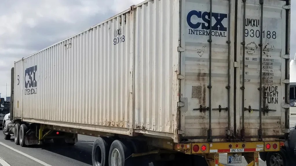 Camión de carga transportando un contenedor en una carretera