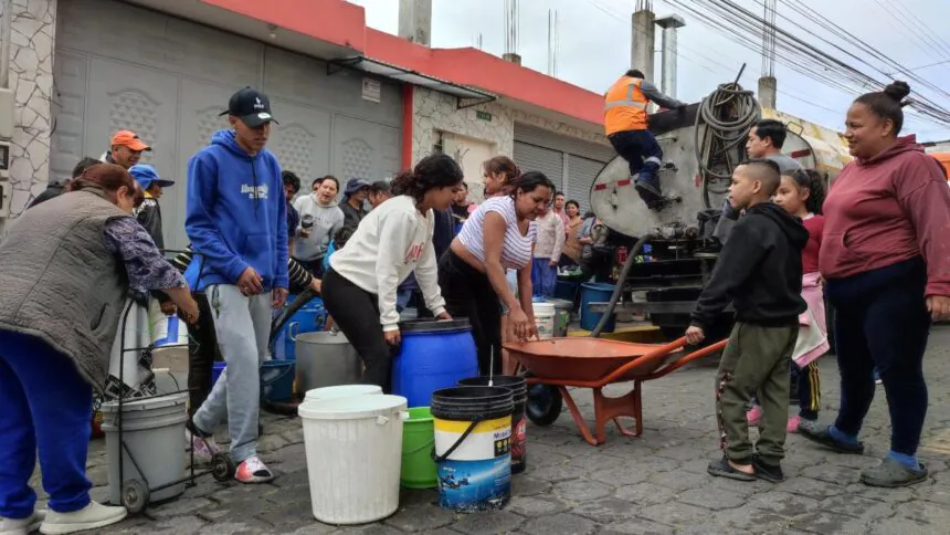 Moradora de Caupichu en el sur de Quito lleva baldes vacíos por escasez de agua potable